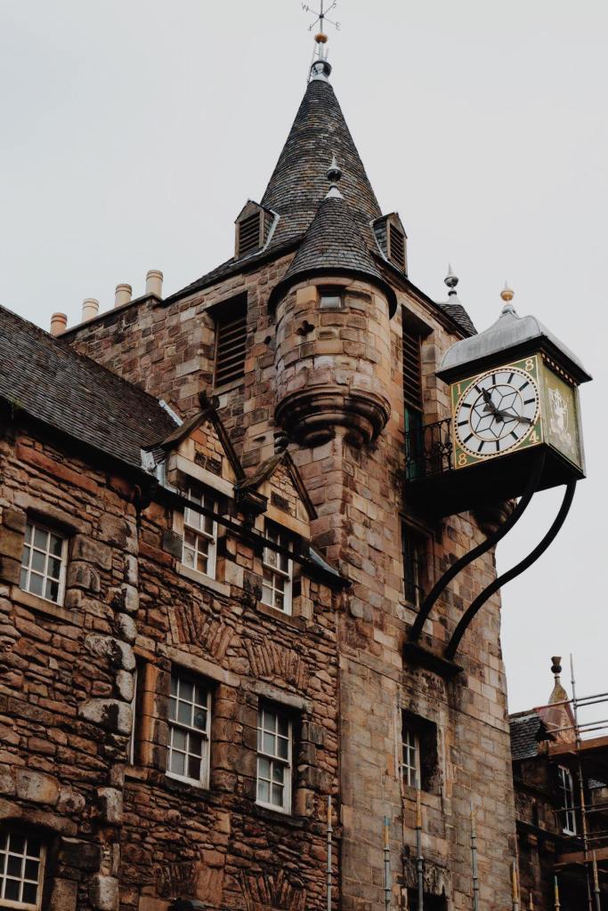 The Tolbooth building with clock tower which houses the People's Story Museum. The brown building has two turrets, and the clock (showing the time 20 past 11) is in a green cube with a white face. 