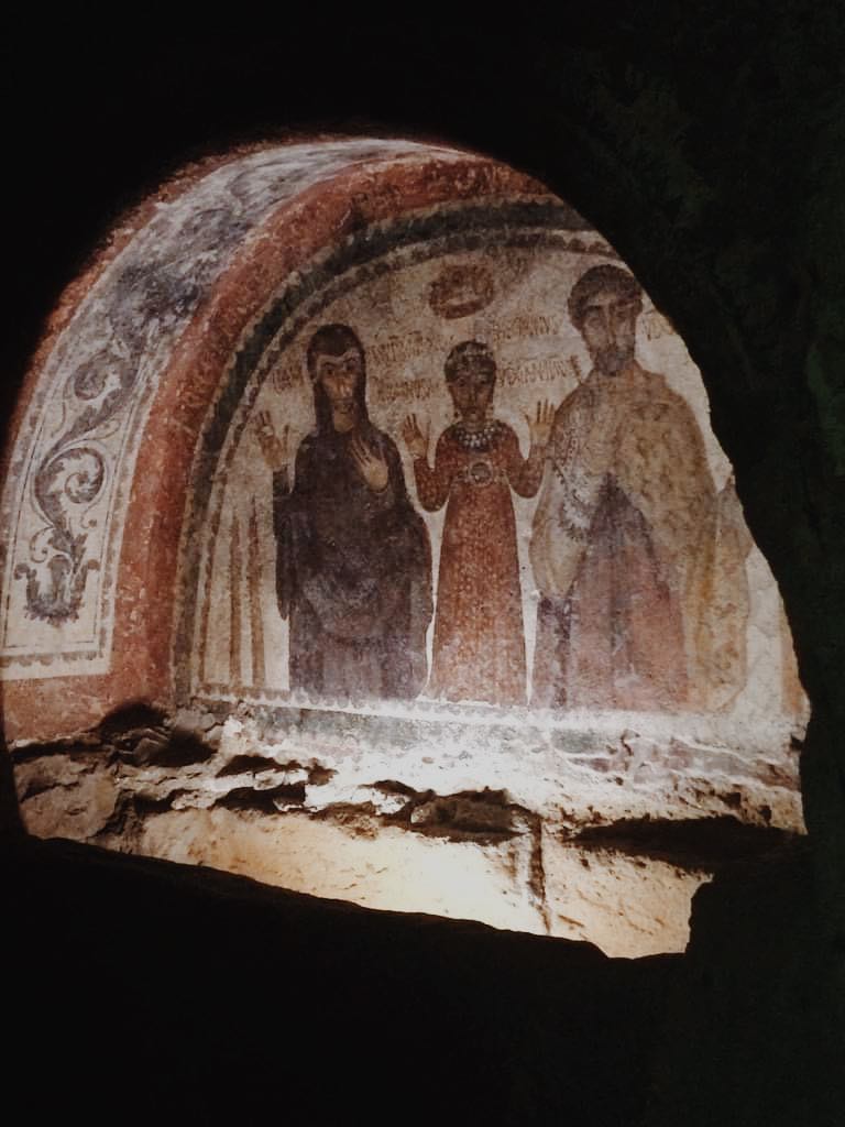 Fresco painting in an alcove in The San Gennaro Catacombs, Naples. Painting of the Thoetecnus family with mother and father and child in the middle.