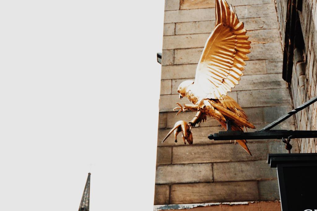 The golden flacon holding a mouse above the door of Gladstones Land on The Royal Mile Edinburgh