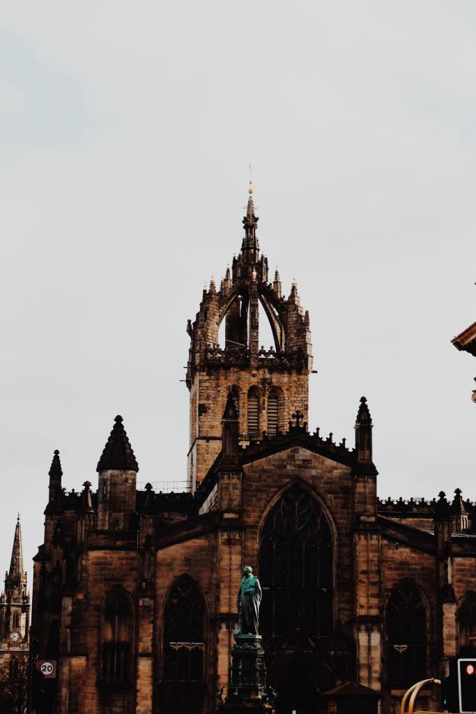 St Giles Cathedral. The steeple is in the shape of a crown. The roof of the building is carved with turrets. 