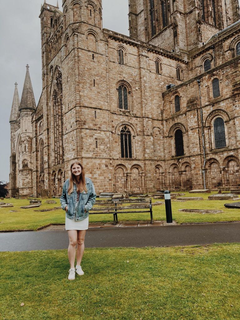 Emily (The Heritage Tourist) standing in front of Durham Cathedral.