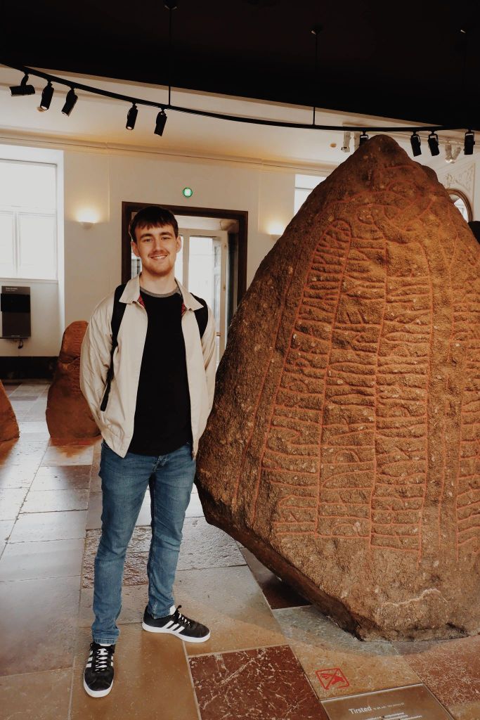 James in front of Rune Stone at the National Museum of Denmark