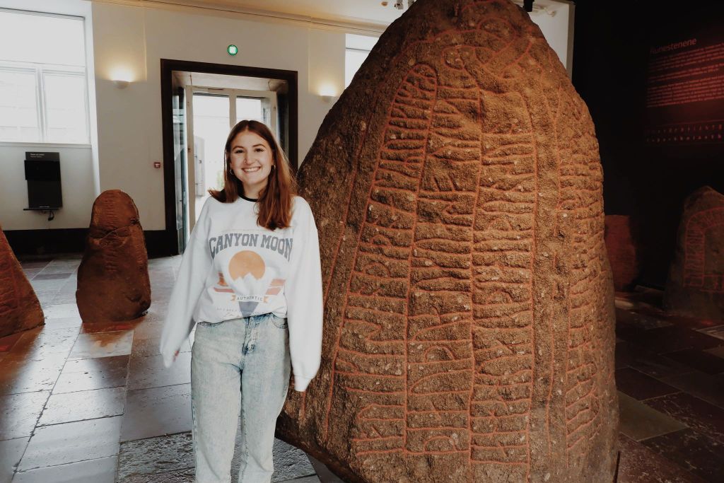 Emily the Heritage Tourist in front of Rune Stone at the National Museum Denmark